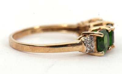 Lot 16 - A 9ct diopside and white stone ring, the three...