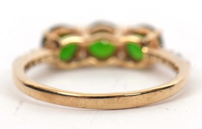Lot 16 - A 9ct diopside and white stone ring, the three...