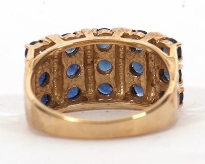 Lot 10 - A 9ct stone blue gemset ring, the three rows...