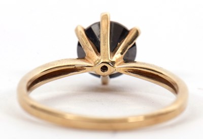 Lot 5 - A 9ct black diamond ring, the round brilliant...