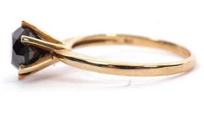 Lot 5 - A 9ct black diamond ring, the round brilliant...