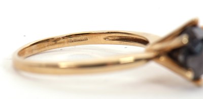 Lot 5 - A 9ct black diamond ring, the round brilliant...