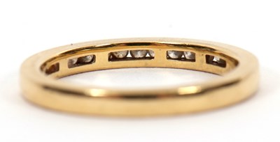 Lot 46 - An 18ct diamond half hoop ring, channel set...