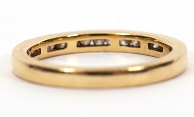 Lot 46 - An 18ct diamond half hoop ring, channel set...