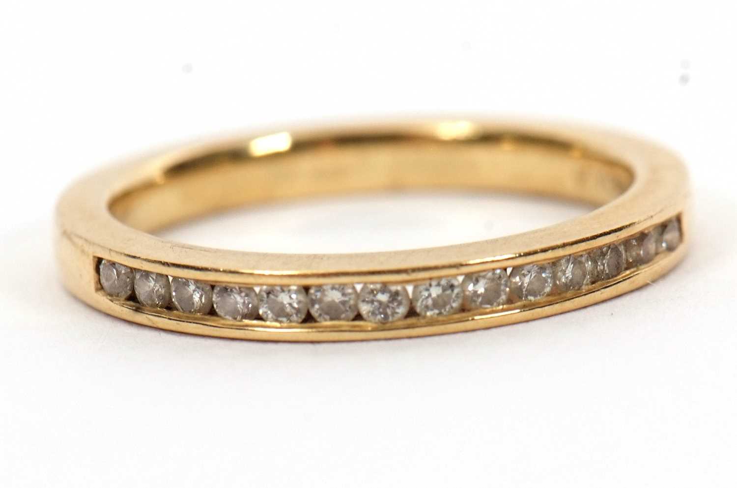 Lot 46 - An 18ct diamond half hoop ring, channel set...
