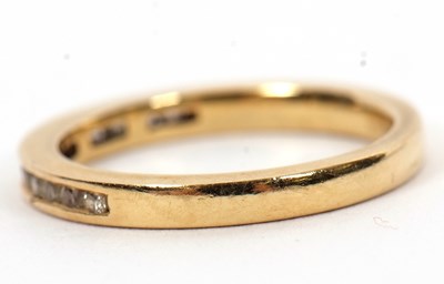Lot 46 - An 18ct diamond half hoop ring, channel set...
