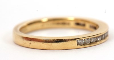Lot 46 - An 18ct diamond half hoop ring, channel set...