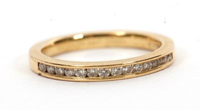 Lot 46 - An 18ct diamond half hoop ring, channel set...