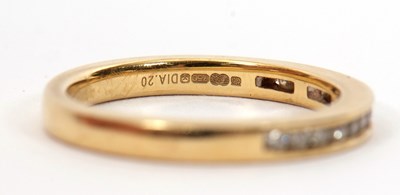 Lot 46 - An 18ct diamond half hoop ring, channel set...