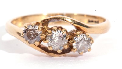 Lot 57 - Three stone diamond cross-over ring featuring...