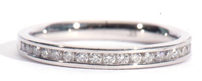 Lot 93 - Platinum and diamond half eternity ring,...