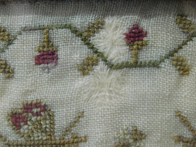 Lot 184 - An early Victorian sampler, with floral motifs...