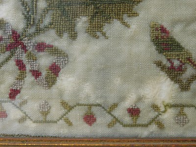 Lot 184 - An early Victorian sampler, with floral motifs...