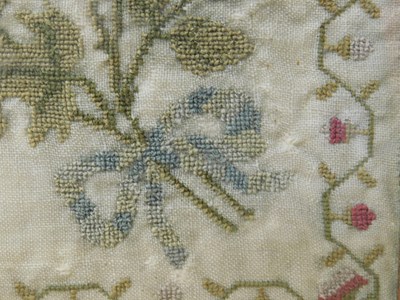 Lot 184 - An early Victorian sampler, with floral motifs...