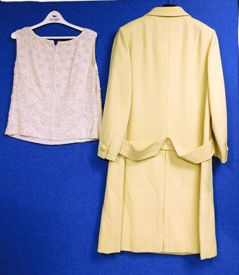 Lot 24 - A mid 20th Century yellow coat by Jean Patou,...
