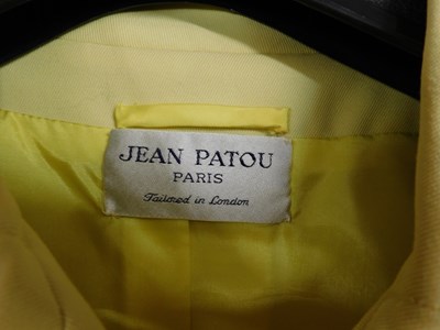 Lot 24 - A mid 20th Century yellow coat by Jean Patou,...