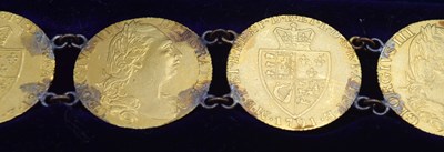 Lot 54 - Bracelet comprising of seven GRIII Gold...