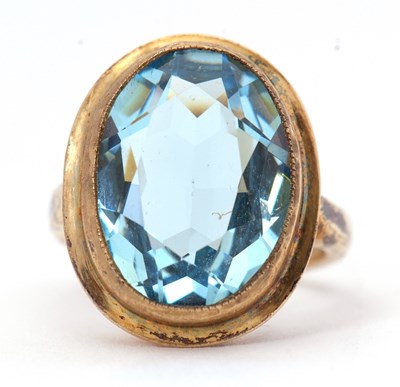 Lot 57 - A silver-gilt blue stone ring, the oval...