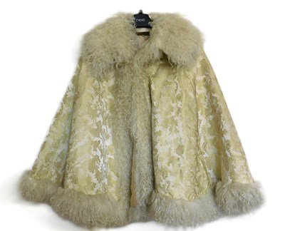 Lot 9 - A cream brocade fur trimmed cape, by Woolright...
