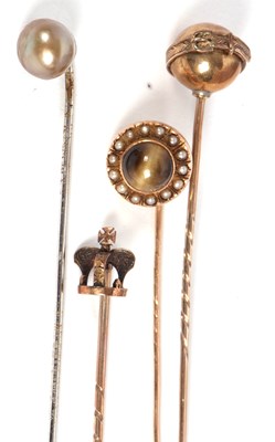 Lot 61 - Four stick pins: to include an unmarked cats...