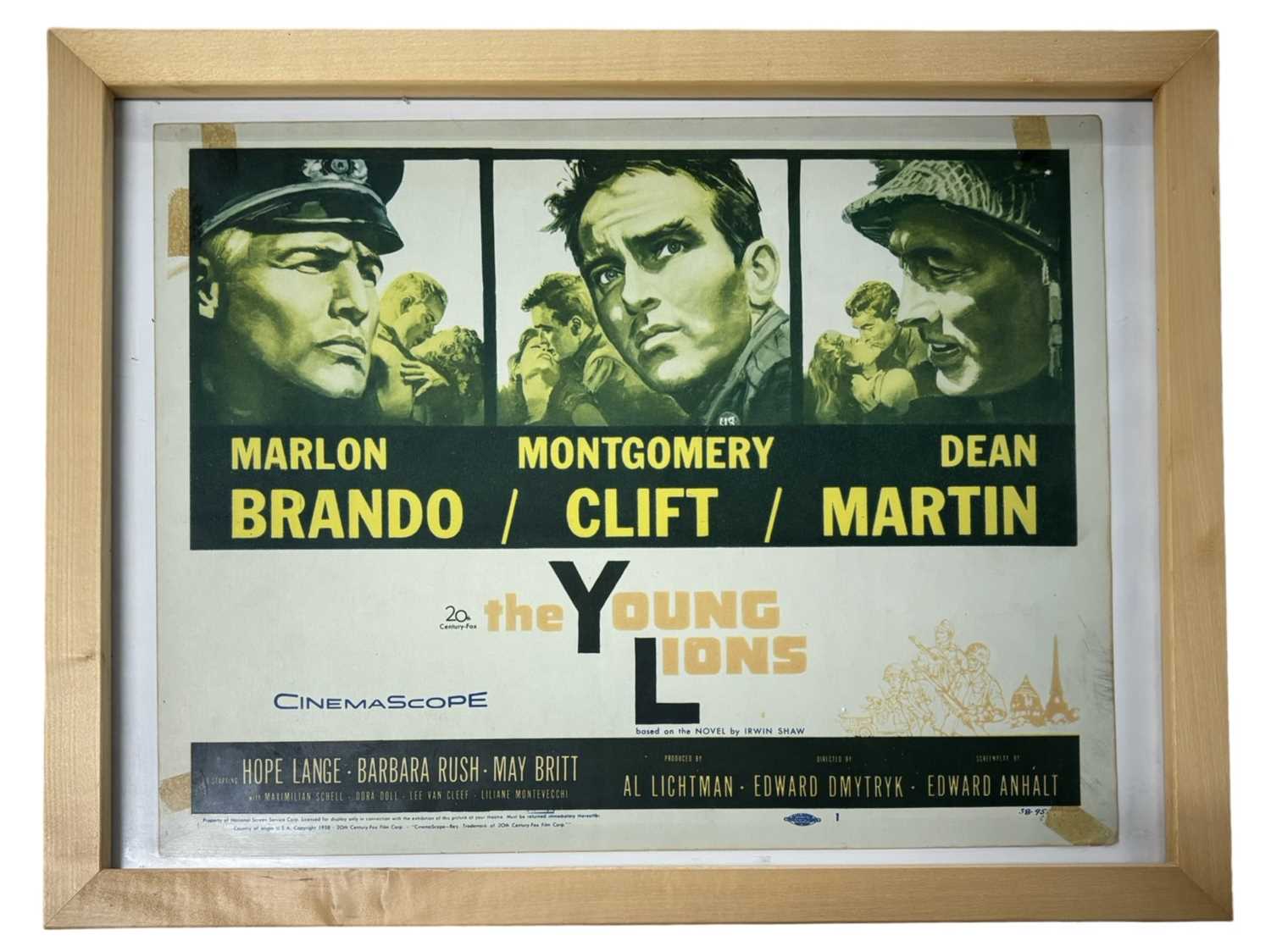 Lot 65 - A framed lobby card for The Young Lions,...