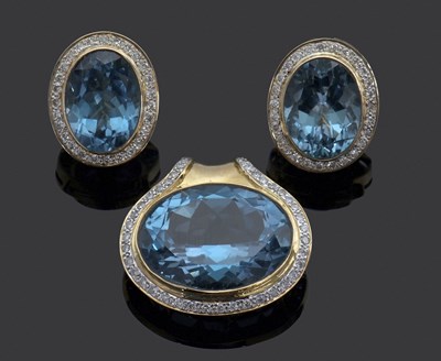 Lot 302 - A topaz and diamond pendant and matching...