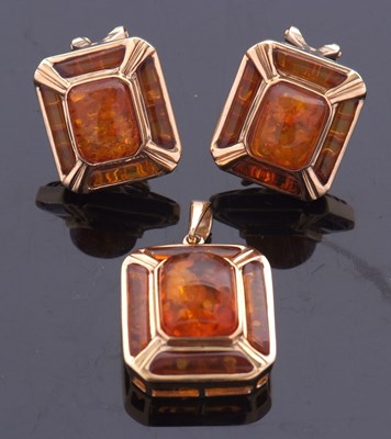 Lot 305 - An amber pendant and matching earrings, the...
