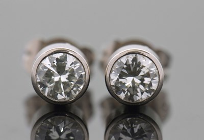 Lot 308 - A pair of 18ct diamond earstuds, the round...