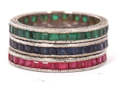 Lot 54 - Three gemset eternity rings: to include a...