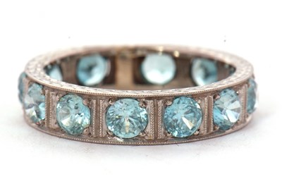 Lot 12 - A zircon eternity ring. the 5mm wide band set...