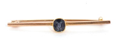 Lot 91 - A spinel bar brooch, the cushion cut dark blue...