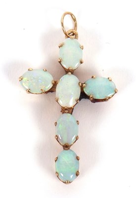 Lot 80 - An opal cross, set throughout with oval opal...