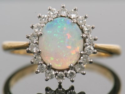 Lot 1 - An 18ct opal and diamond ring, the oval opal...