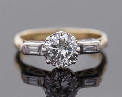 Lot 293 - A diamond ring, the central round brilliant...