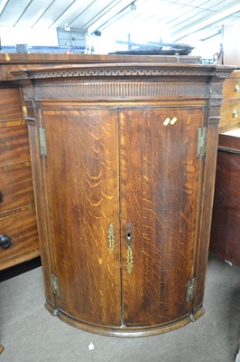 Lot 470 - A Georgian oak wall mounted corner cabinet of...