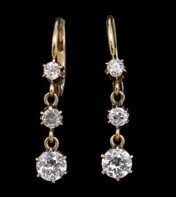 Lot 274 - A pair of diamond earrings, the three...