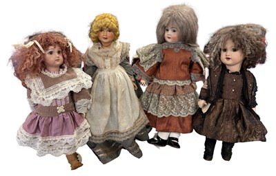 Lot 213 - A collection of four small collector's dolls,...