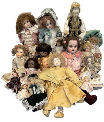 Lot 220 - A collection of various miniature dolls of...