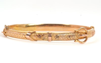 Lot 147 - A Victorian buckle bangle, the hinged bangle...
