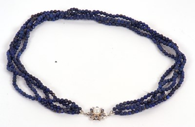 Lot 136 - An 18ct lapis lazuli bead necklace, the four...