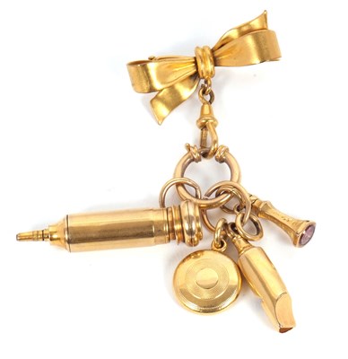Lot 165 - A bow brooch and charms, the unmarked bow...