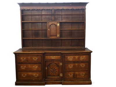 Lot 340 - A large Georgian oak dresser formed of two...