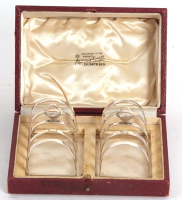 Lot 47 - A small pair of cased George V silver toast...