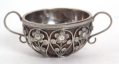 Lot 110 - An antique white metal twin handled coconut...