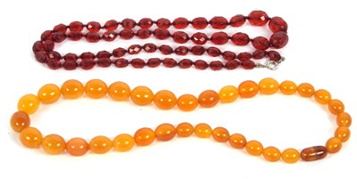 Lot 218 - Two faux amber bead necklaces: one with...