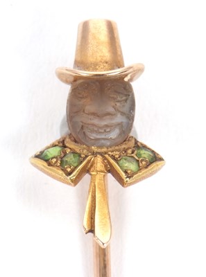 Lot 68 - A leprechaun stick pin, the carved moonstone...