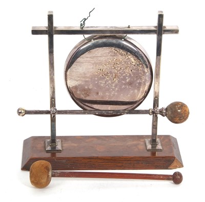 Lot 201 - A vintage silver plated dinner gong on an oak...
