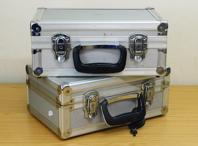 Lot 111 - A pair of hard shell aluminum camera cases,...