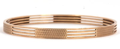 Lot 114 - A gold bangle, the four bands with solid...