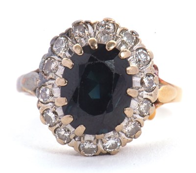 Lot 19 - A sapphire and diamond ring, the oval sapphire...